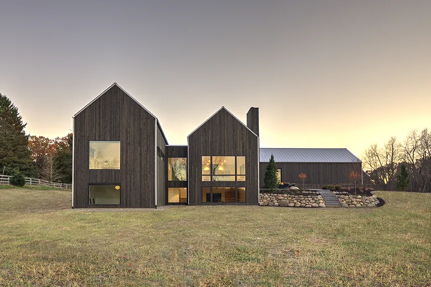 Modern farmhouse with charred wood siding, sold by Rebecca Vandenbroek in Ada, MI