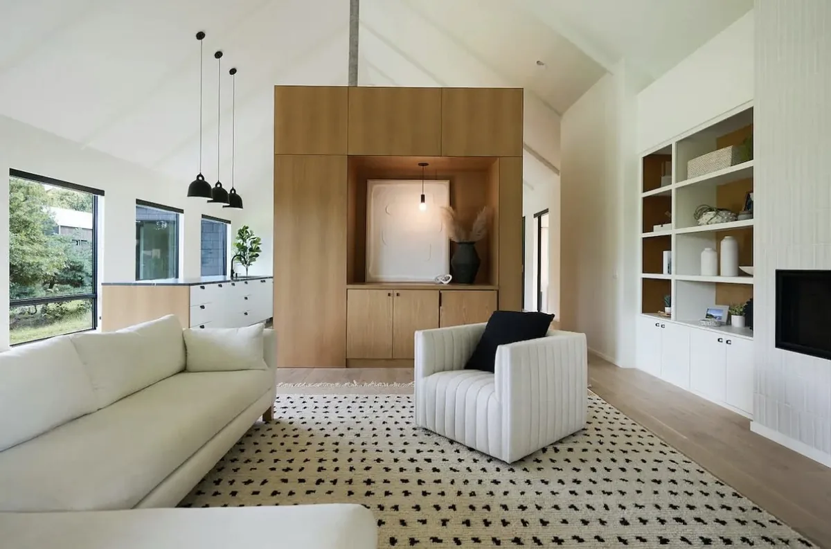 Vaulted living room with white oak cabinetry and natural light in Ada, MI
